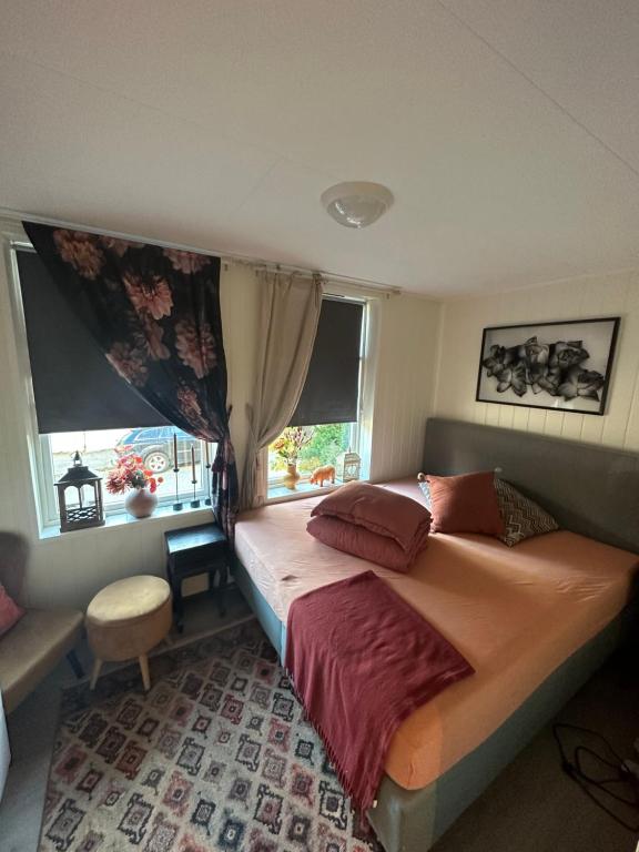 a bedroom with a large bed and a window at Downtown Historical House with Renovated apartments in Ålesund