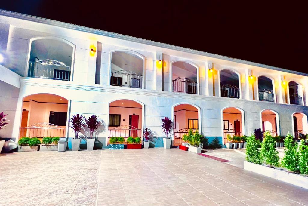a large white building with a courtyard at night at Hori hotel in Ban Nong Khaman