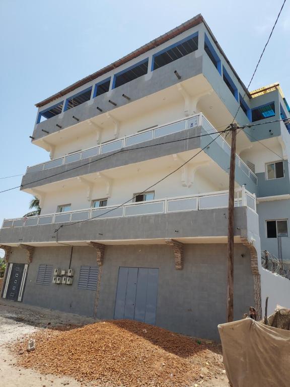 a building with a balcony on the side of it at Chez Manga in Ziguinchor