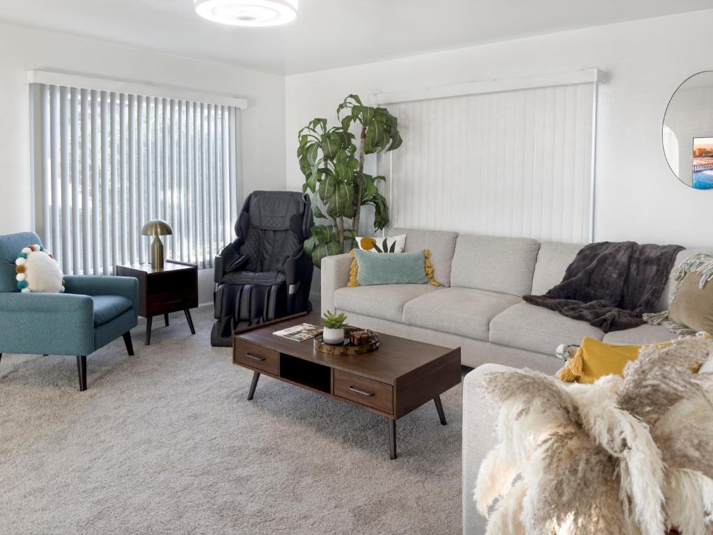 ein Wohnzimmer mit Couch und Tisch in der Unterkunft Quaint Mid-Century Cottage by the Coast in Ventura