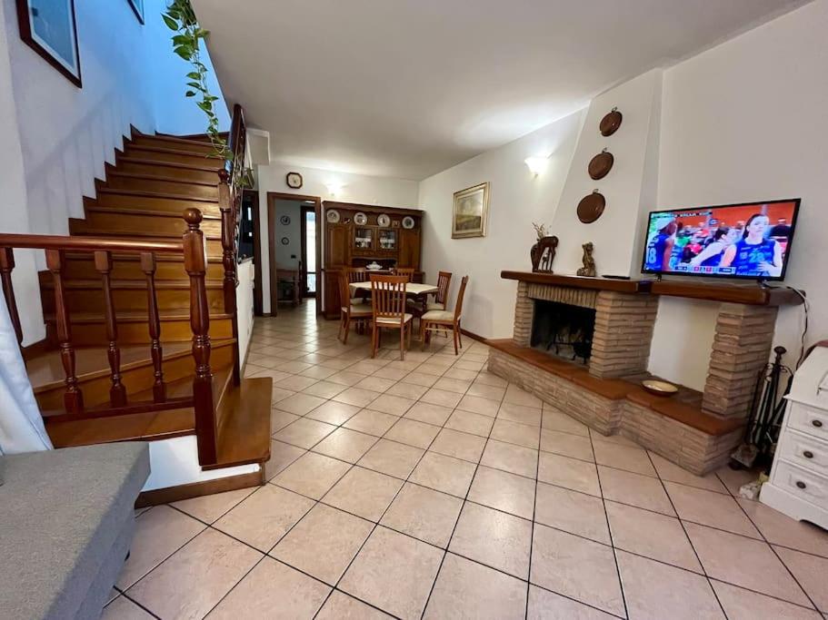 a living room with a fireplace and a tv at Vacanze Versilia in Viareggio