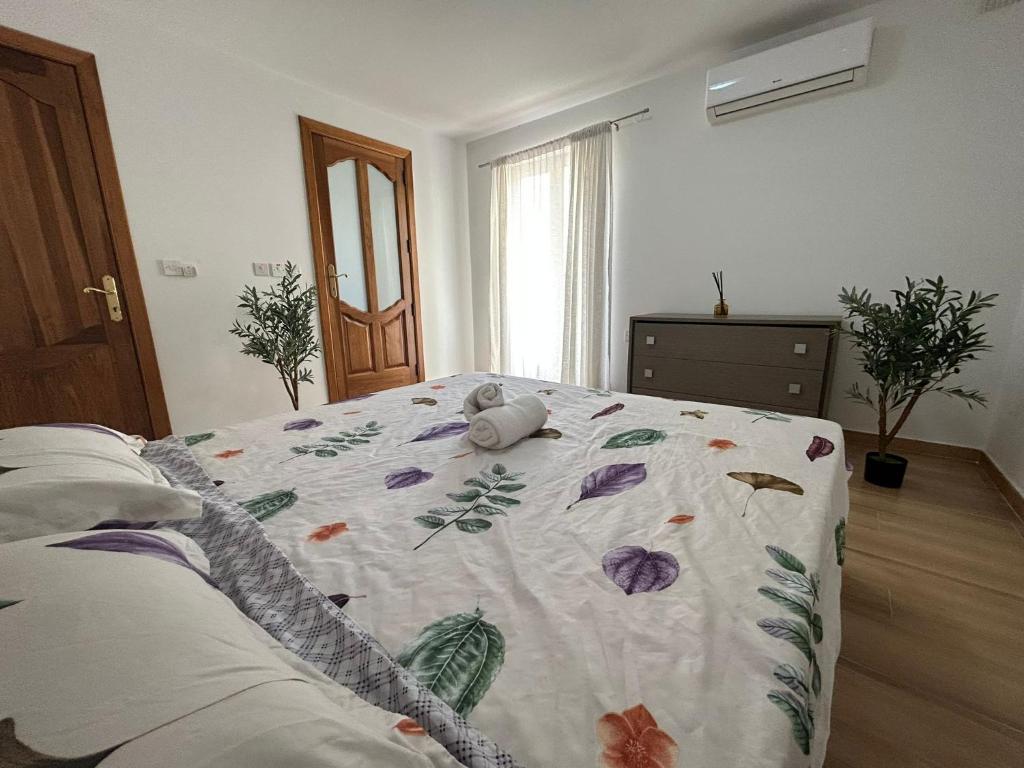 a bedroom with a bed with a flower blanket on it at Luxurious Sliema Ferry central location in Sliema