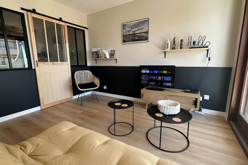 a living room with a bed and two chairs at Destination Léman in Thonon-les-Bains