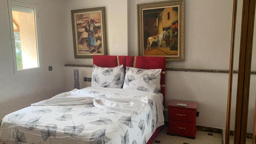 a bedroom with a bed and a painting on the wall at villa palace in Douar Oulad Jaber