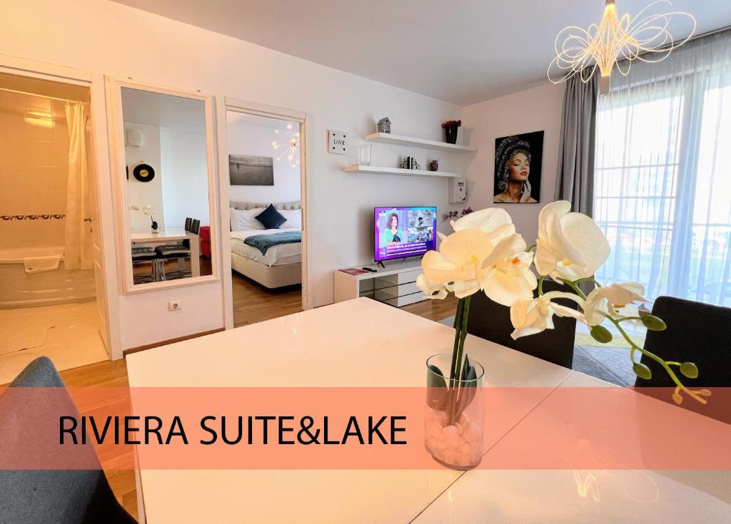 una sala de estar con un jarrón de flores sobre una mesa en Red Hotel Riviera Suite&Lake en Cluj-Napoca