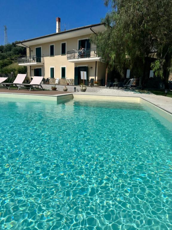 a large swimming pool in front of a house at Villa Le Torrette in Agropoli