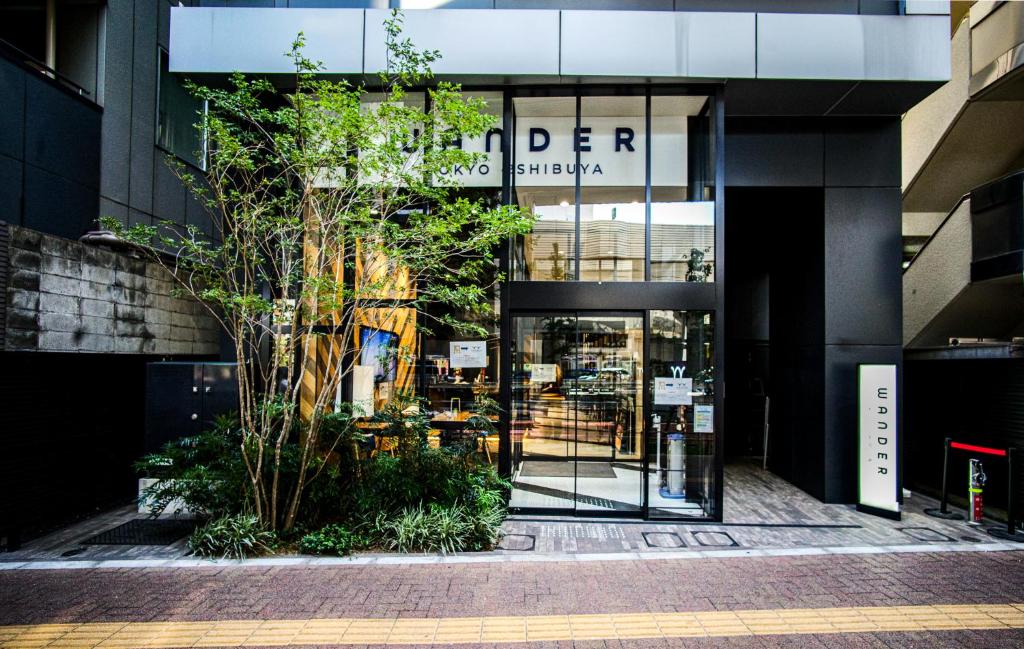 a store front with the entrance to a building at Wander Tokyo Shibuya in Tokyo