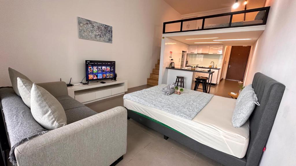 a bedroom with a bed and a couch at KL Sentral Loft, EST Bangsar #6, LRT in Kuala Lumpur