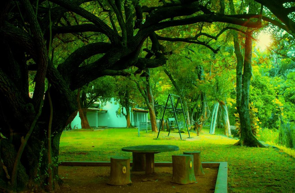 a park with a picnic table and a playground at New Rest House Inn in Mahiyangana