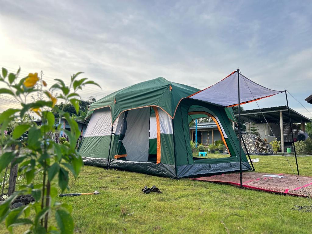 a green tent on the grass in a field at PJ Kingdom แคมป์ 