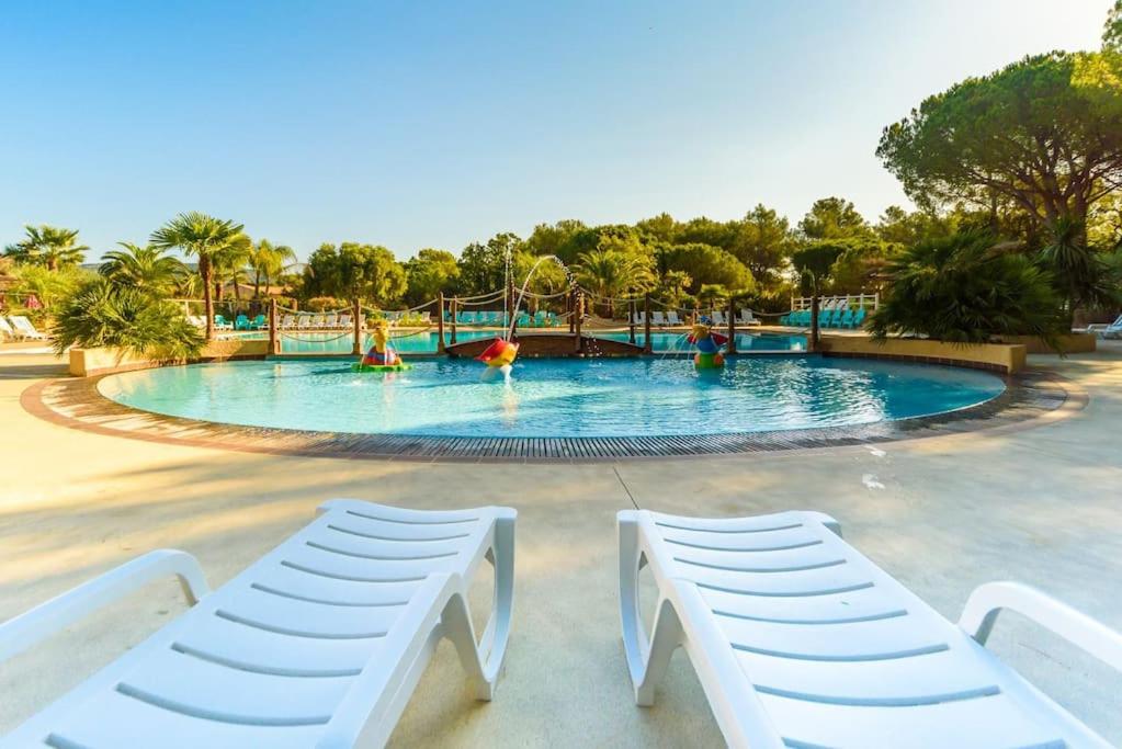 a large swimming pool with people in the water at Mobile home 5-pers Camping Leï Suves-Côtes d&#39;Azur-including airco in Roquebrune-sur-Argens