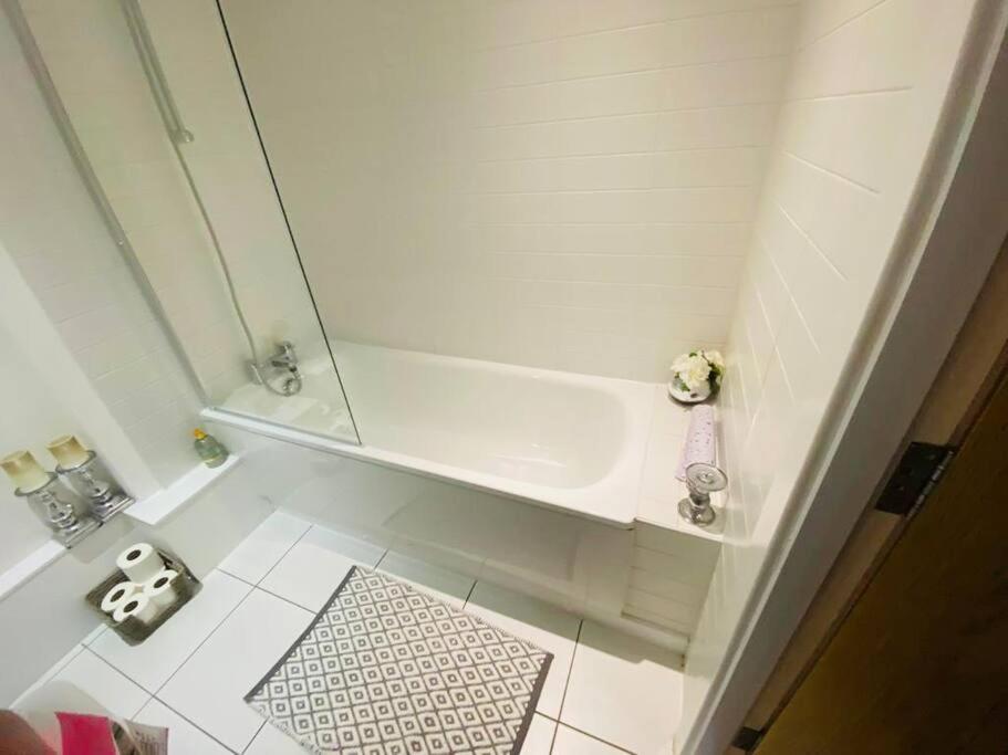 a bathroom with a shower and a sink and a rug at Liverpool City Centre Modern Apartment fits 6 people in Liverpool