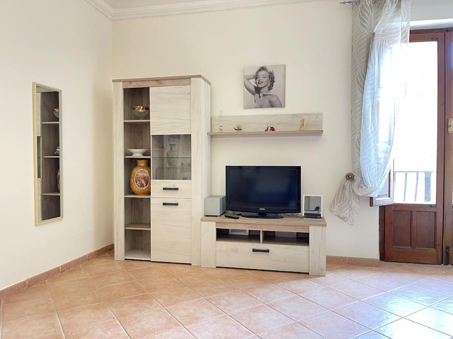 sala de estar con mesa y TV en Appartamento Garibaldi centro Sicilia., en Barrafranca