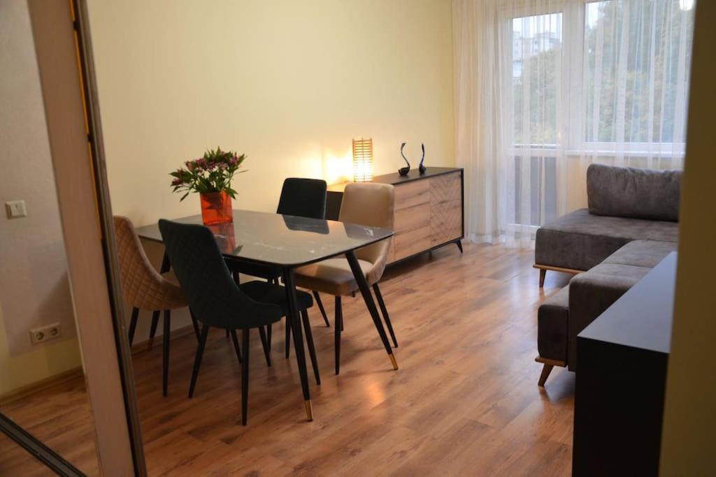 un soggiorno con tavolo, sedie e divano di Apartment in Vilnius a Vilnius