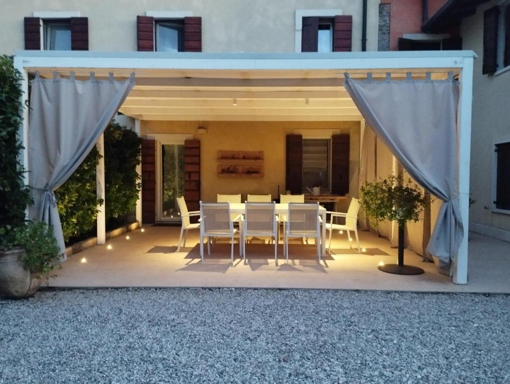 uma mesa e cadeiras num pátio com uma tenda em Appartamento La Corte Verona em Verona
