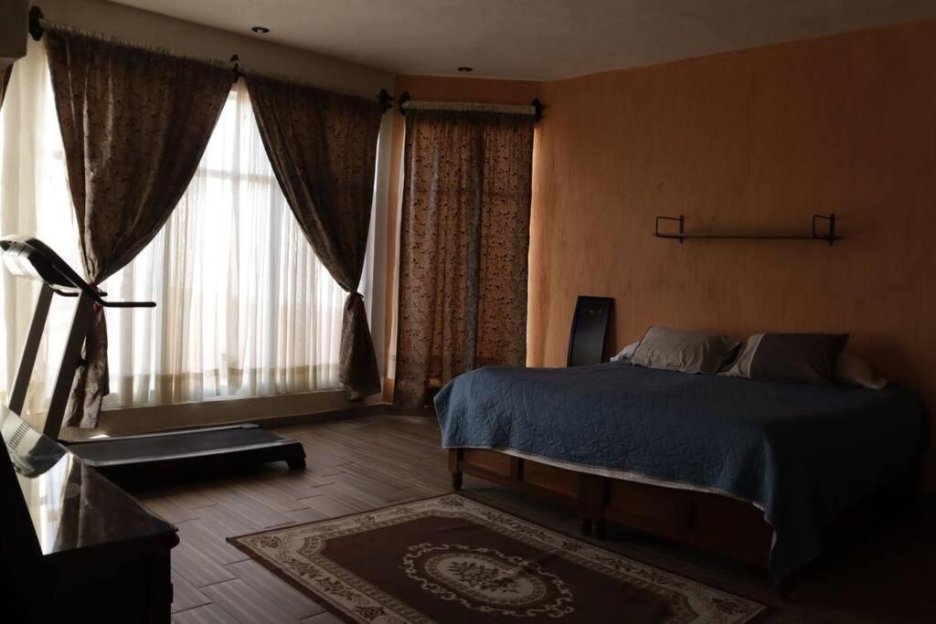 Giường trong phòng chung tại Escape Sereno en Quinta Tabachín Con Alberca