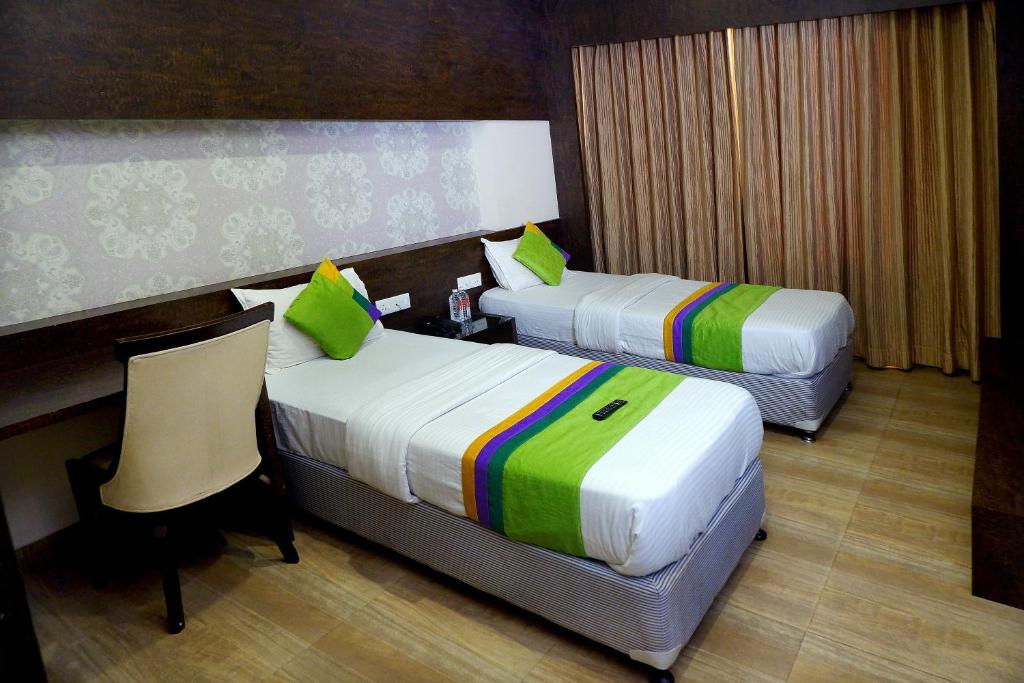 Postel nebo postele na pokoji v ubytování Hotel Sai Vijay