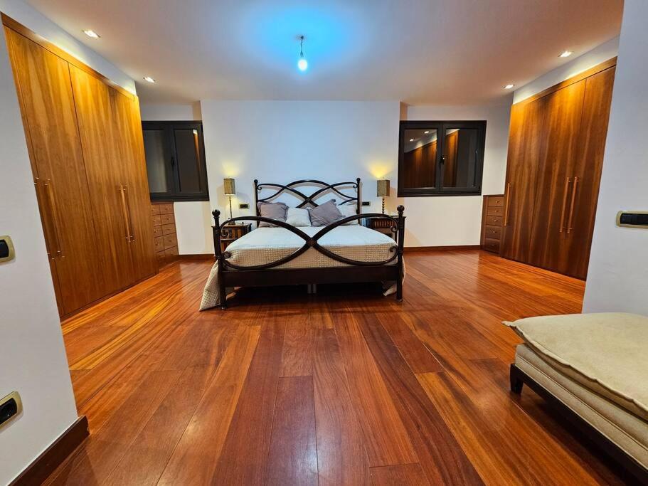 a bedroom with a bed and a wooden floor at Mirador La Jirafa - 638A in Oviedo