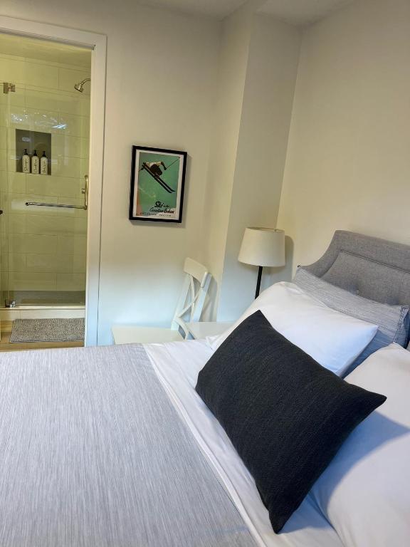 a bedroom with a bed and a walk in shower at Mountain View Bed & Breakfast in Banff