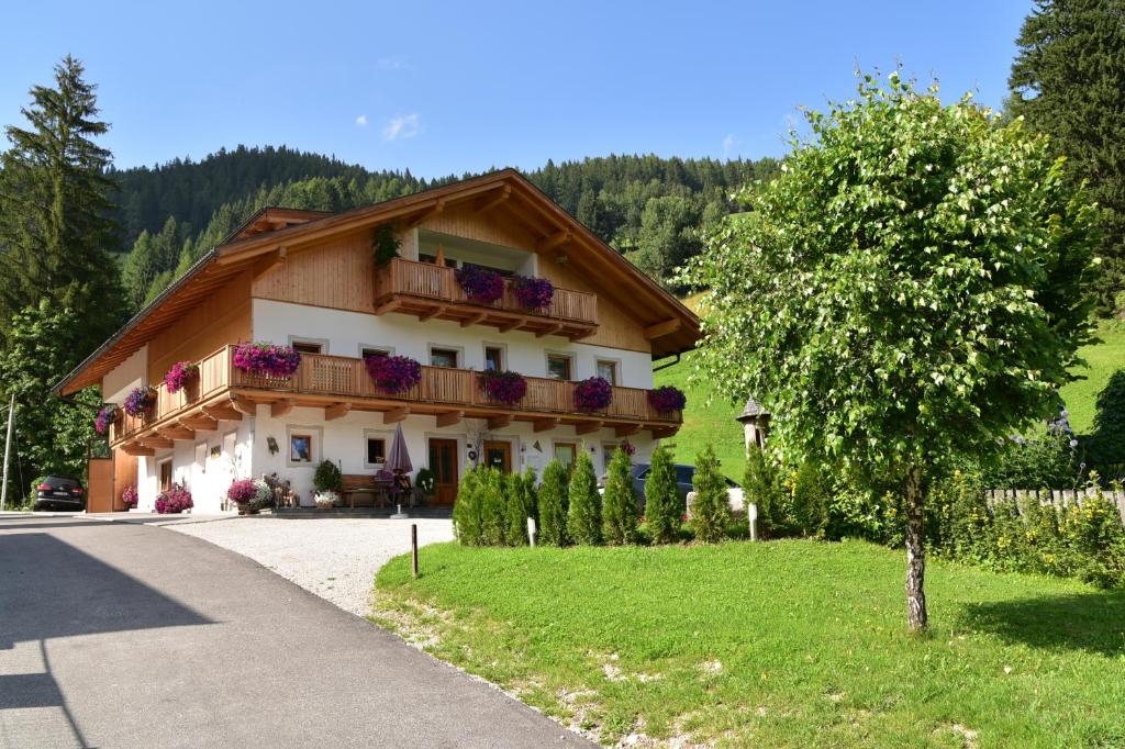 a house with a balcony on the side of a road at Apartement Schuster Lake Prags Braies in Braies