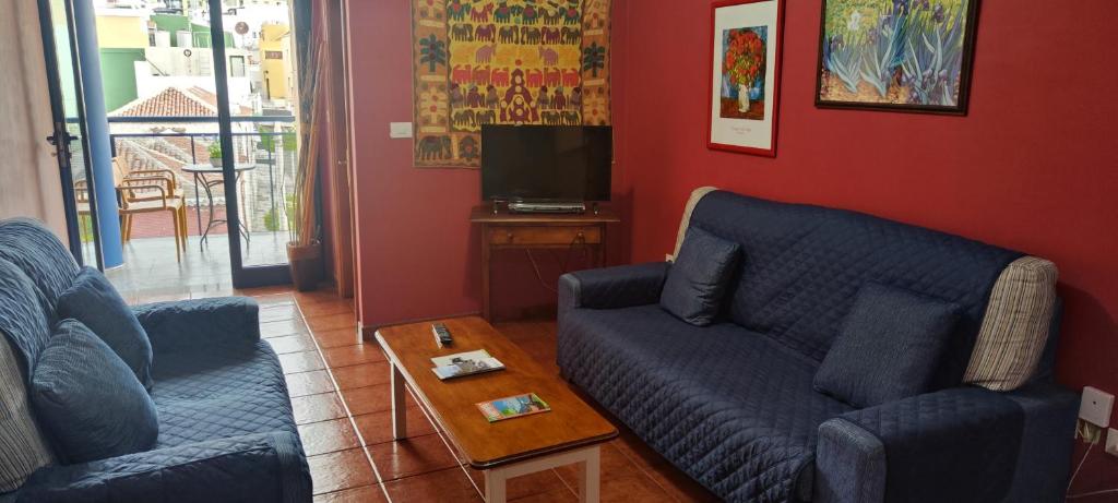 - un salon avec deux canapés bleus et une table basse dans l'établissement Bonito y amplio piso en Los LLanos de Aridane, à Los Llanos de Aridane