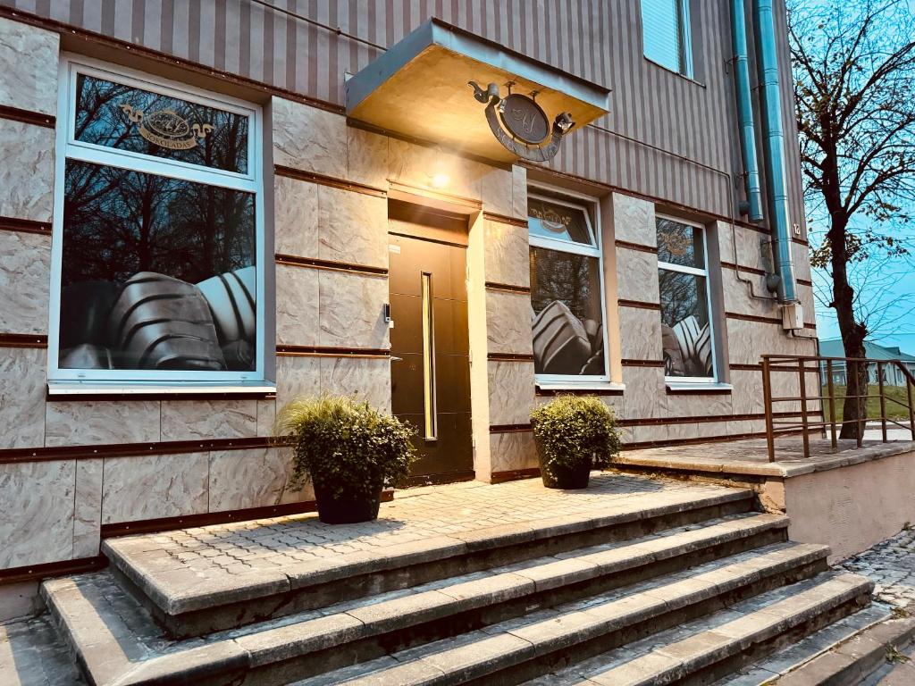 a house with stairs leading up to the front door at AJ Chocolate Vilnius in Vilnius