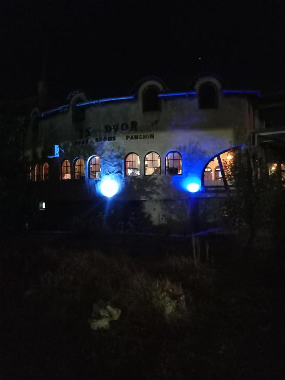 a building lit up at night with blue lights at BUMBAR ETNO DVORAC in Tekija