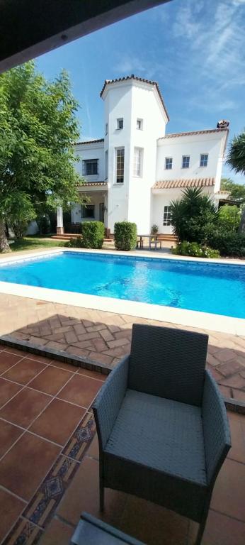 a villa with a swimming pool in front of a house at Casa Victoria in Arcos de la Frontera
