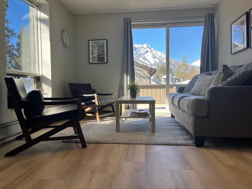 a living room with a couch and a chair and a table at Mountain View Bed & Breakfast in Banff