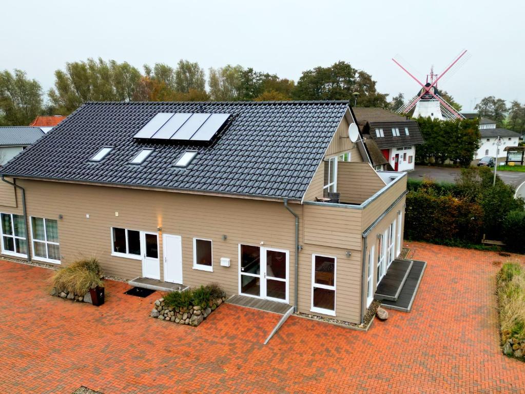 a house with solar panels on the roof at Haus zwischen den Wehlen bei Büsum, 16 Personen in Westerdeichstrich