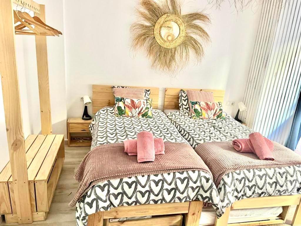 a bedroom with two beds and a mirror on the wall at Alzira bonita Loft A junto plaza mayor, la Murta in Alzira