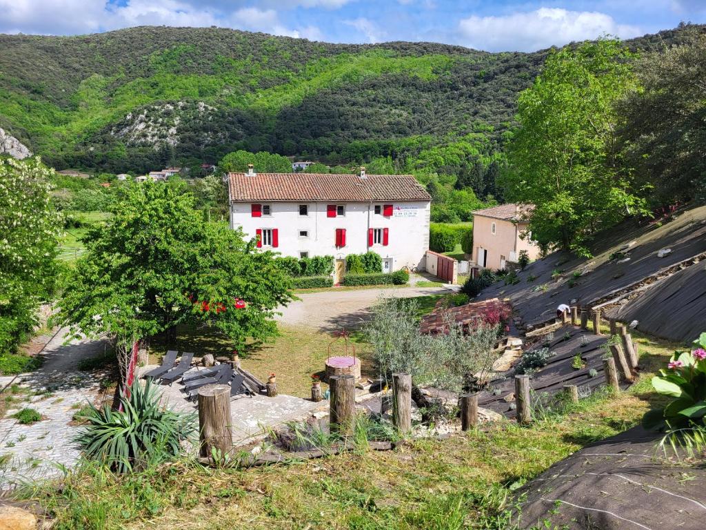 ein weißes Haus inmitten eines Berges in der Unterkunft Chambre d'hôte Le Clos d'Audio à Riols in Riols
