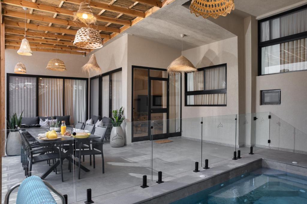 a house with a swimming pool and a dining room at Diamond in the Desert- for families in Eilat