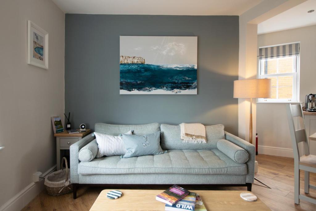 a living room with a couch and a table at Church St. Retreat, Filey in Filey
