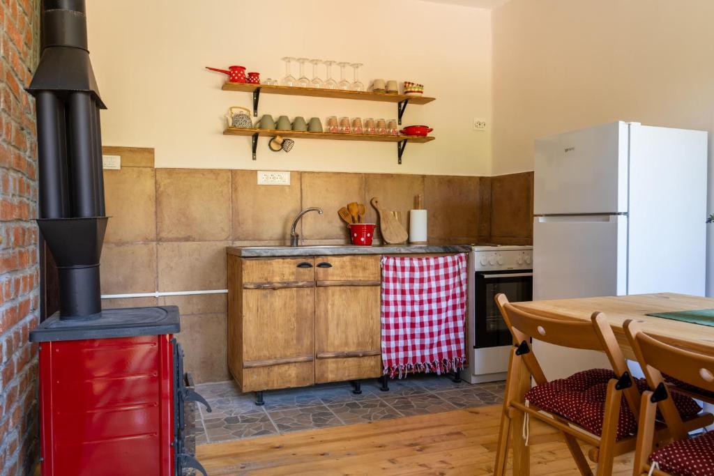a kitchen with a stove and a table at Mir i planina 