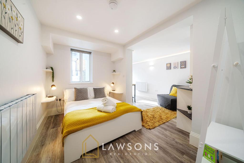 a white bedroom with a large bed and a couch at Central Living by Lawsons in Windsor