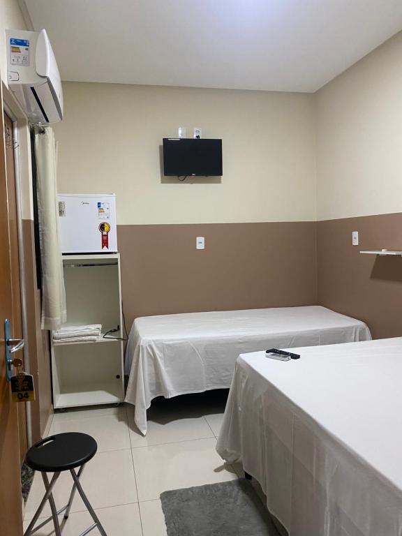 um quarto de hospital com duas camas e uma televisão em Center Prime Hotel em Bom Jesus da Lapa