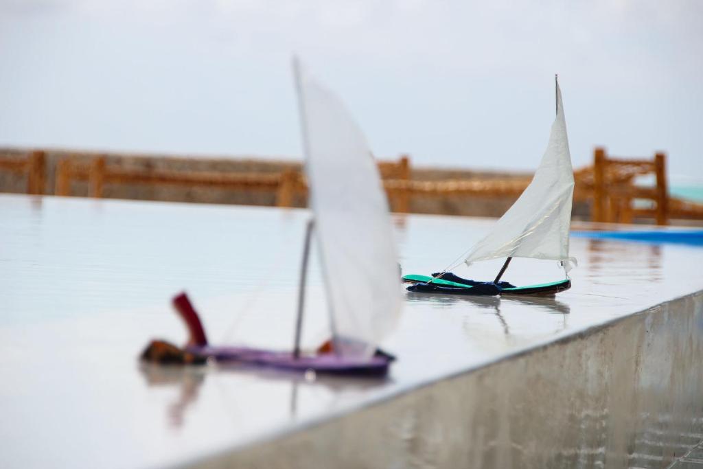 two miniature sailboats sitting on top of a counter at Nur Beach Hotel in Jambiani
