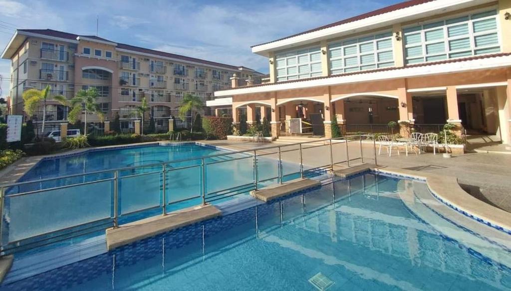 a large swimming pool in front of a building at Homestay Arezzo Place Davao - Building 9 in Davao City