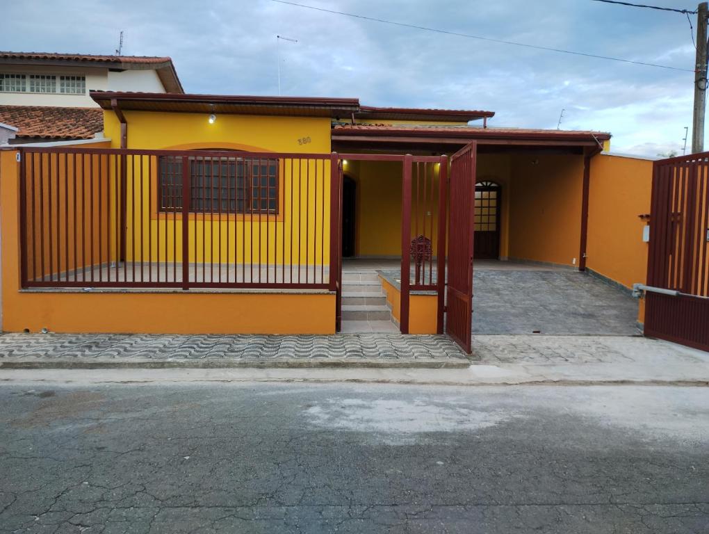 une maison jaune et orange avec un portail dans l'établissement Casa de Bençãos de Aparecida., à Aparecida