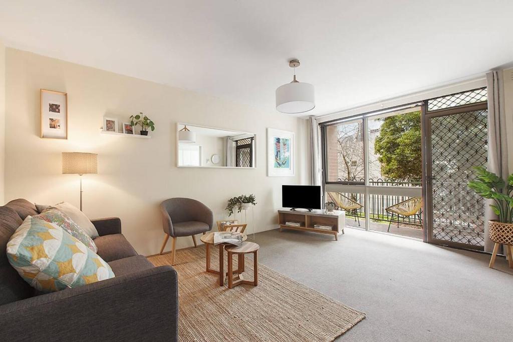 a living room with a couch and a tv at Spacious Suburban Comfort Perfect for Families in Melbourne