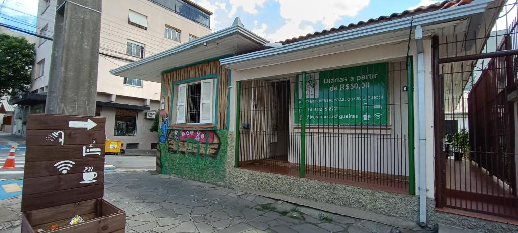 a building with a sign on the side of a street at Casarão 2 in Caxias do Sul
