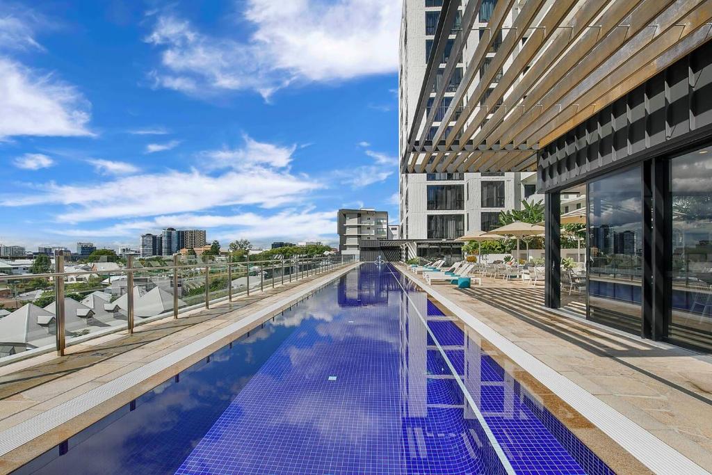 a swimming pool on the roof of a building at 'Brightly Boutique' A CBD Resort-style Escape in Brisbane