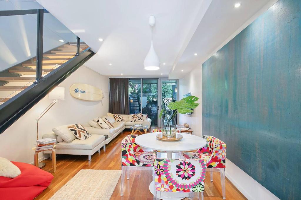 a living room with a couch and a table at The Sun Catcher - A Trendy South Brisbane Townhouse in Brisbane