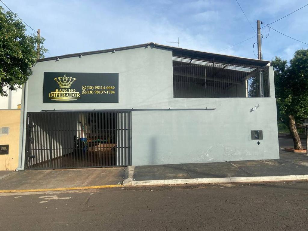 a white building with a sign on the side of it at Rancho Imperador in Pôrto Primavera