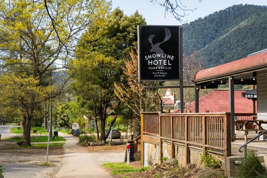 a sign for a show me your hotel next to a building at The Harrietville Snowline Hotel in Harrietville