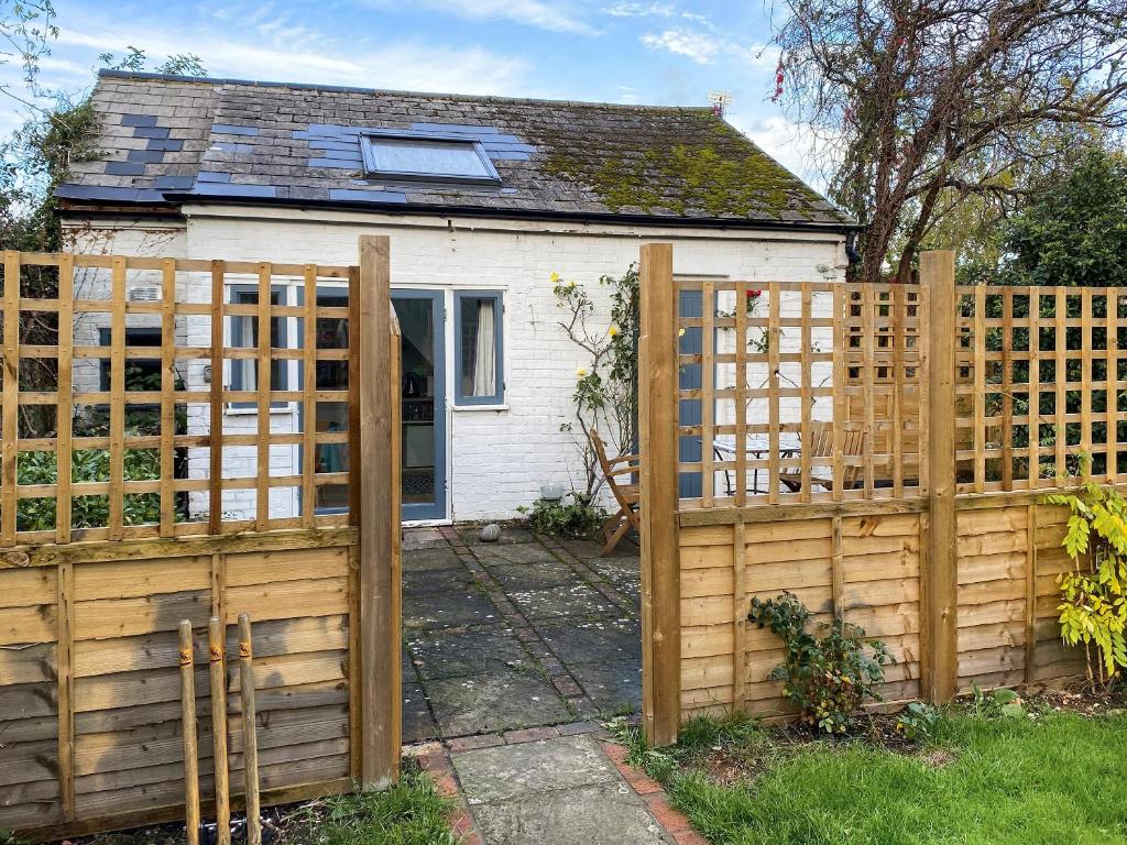 a wooden fence in front of a house at Old Tile Studio Annex in Bramber