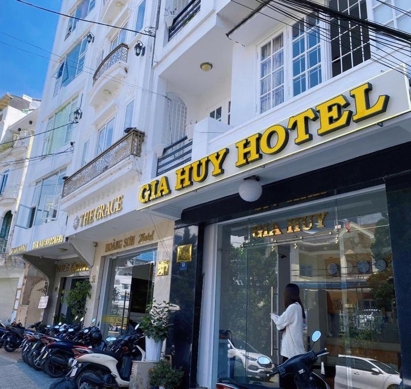 un hombre parado en la ventana de una tienda en Glory Gia Huy Hotel, en Da Lat