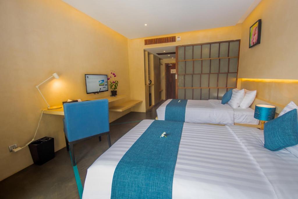 Postel nebo postele na pokoji v ubytování Sakmut Boutique Hotel