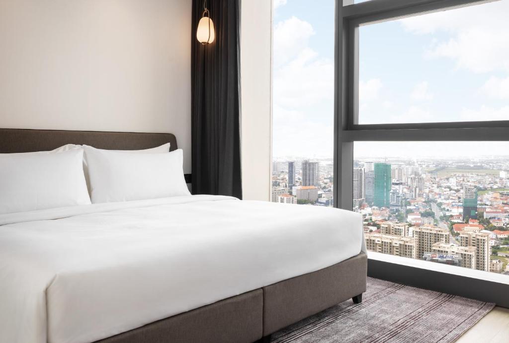Postel nebo postele na pokoji v ubytování Citadines Flatiron Phnom Penh